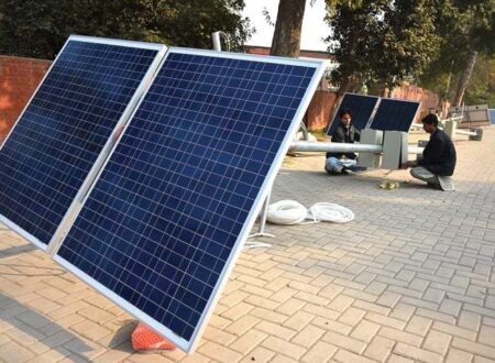A row of solar-powered streetlights lit up at dusk along a major road in Islamabad, showcasing over 60 % solar coverage