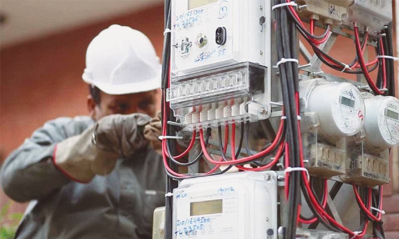 WAPDA engineers installing a smart electricity meter on a residential/commercial building in Lahore under the anti-theft initiative.
