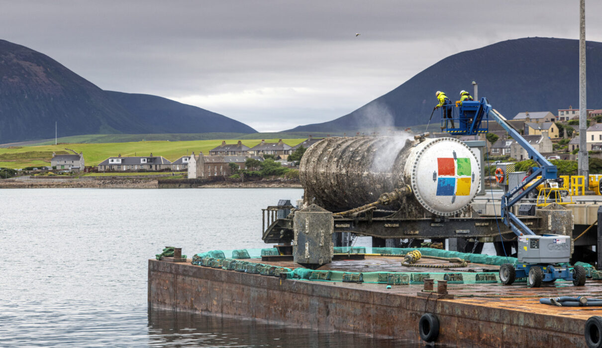 An underwater data center module installed on the seabed off Japan's coast, connected via fiber-optic and power lines with natural cooling from surrounding sea water.