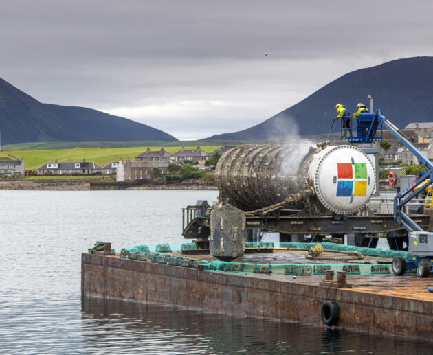 An underwater data center module installed on the seabed off Japan's coast, connected via fiber-optic and power lines with natural cooling from surrounding sea water.