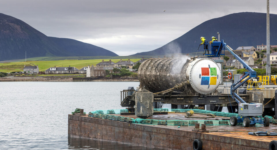 An underwater data center module installed on the seabed off Japan's coast, connected via fiber-optic and power lines with natural cooling from surrounding sea water.