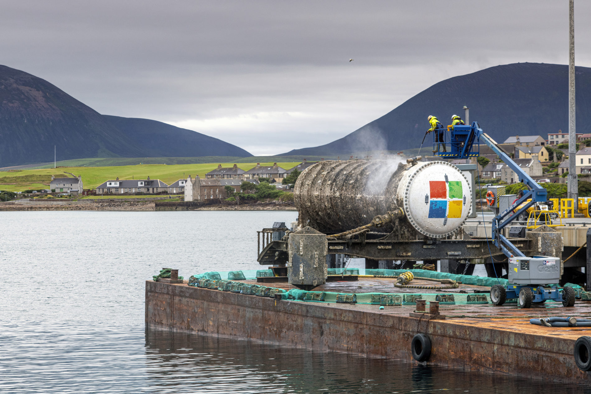An underwater data center module installed on the seabed off Japan's coast, connected via fiber-optic and power lines with natural cooling from surrounding sea water.